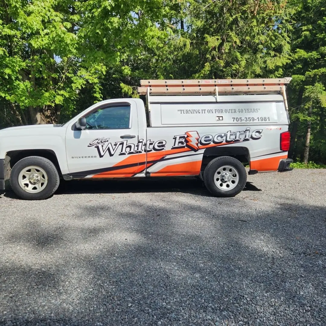 White Electric pickup with orange and black lettering