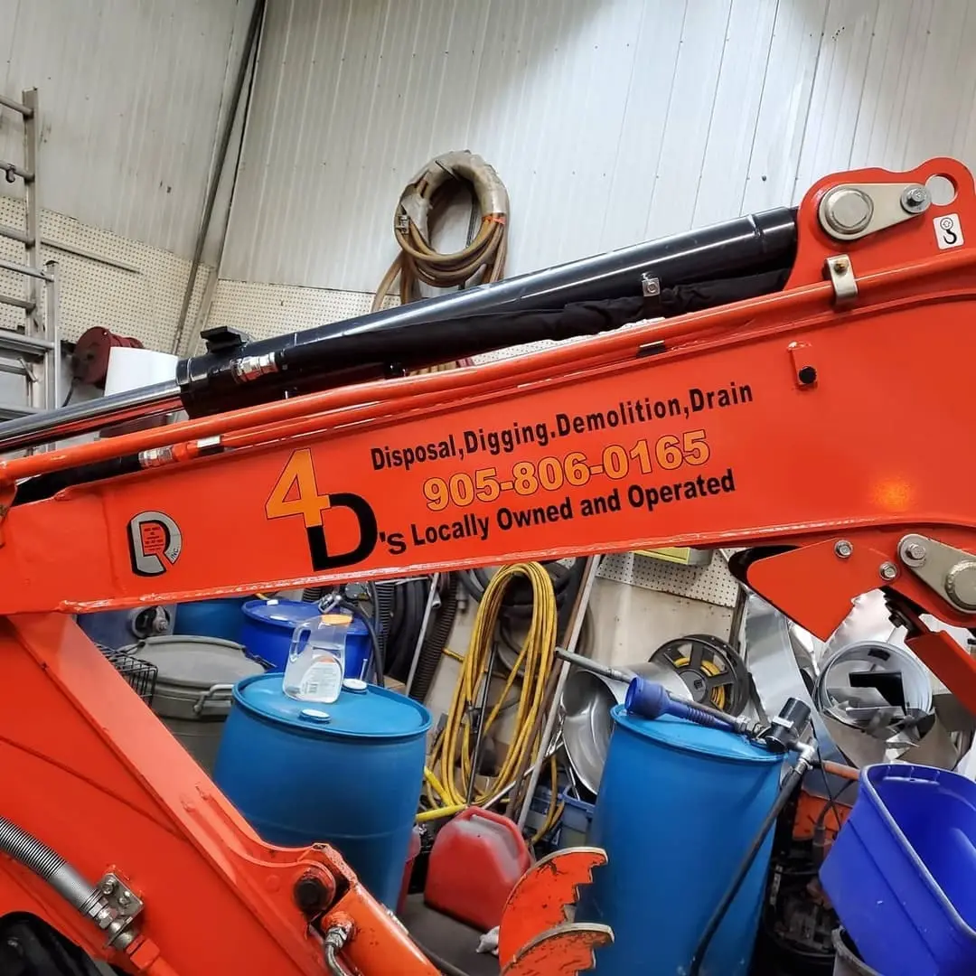 Orange Kubota excavator with lettering