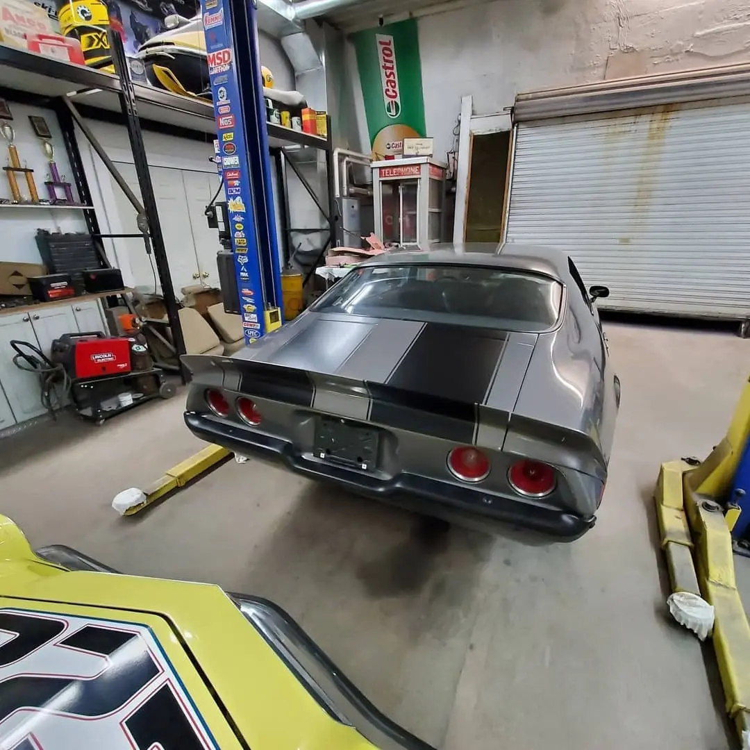 Yellow classic Camaro with black stripes