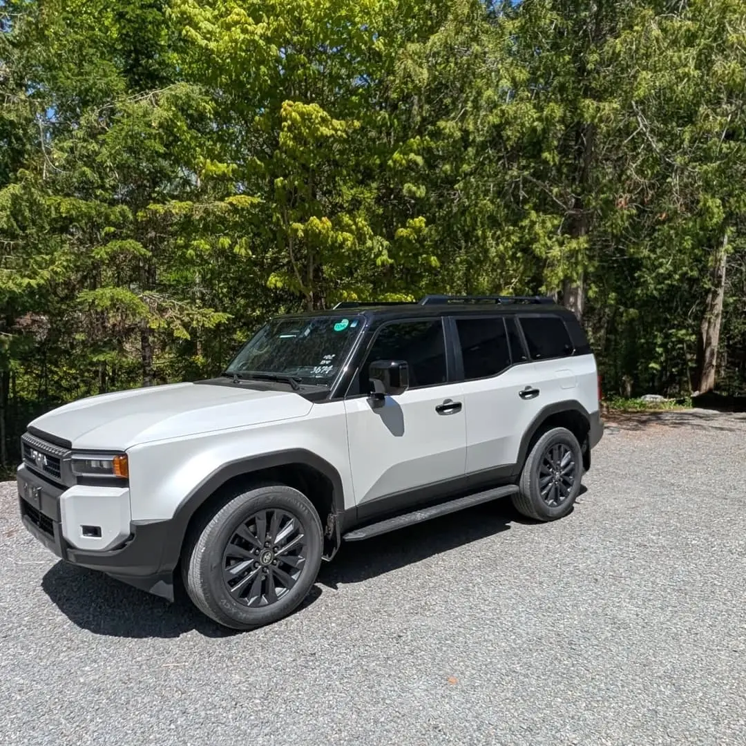 White Toyota Land Cruiser with a black roof wrap