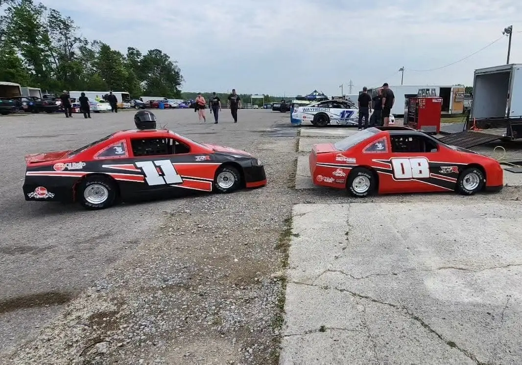 Two small race cars wrapped and ready for the track