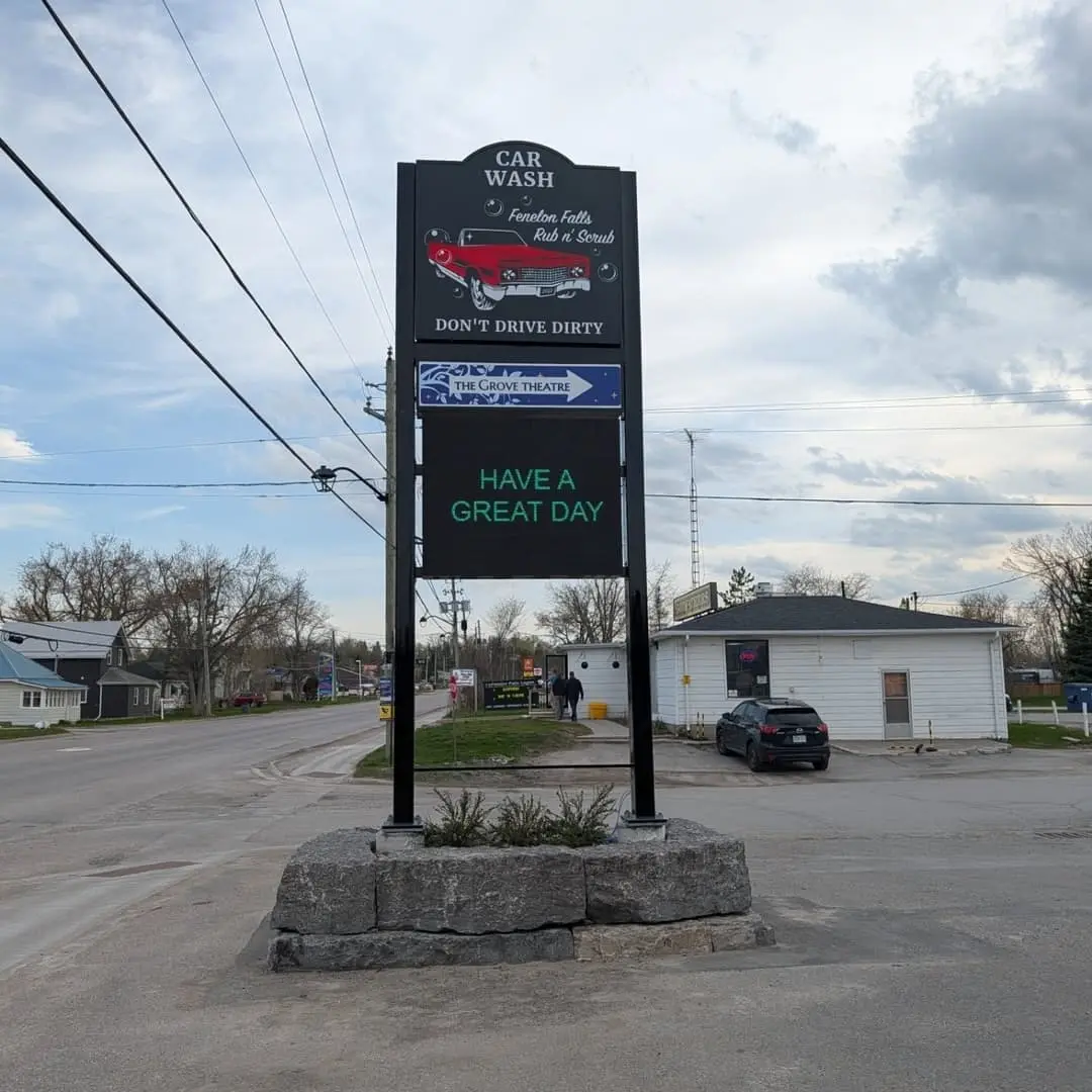 Fenelon Falls car wash road sign with a digital screen
