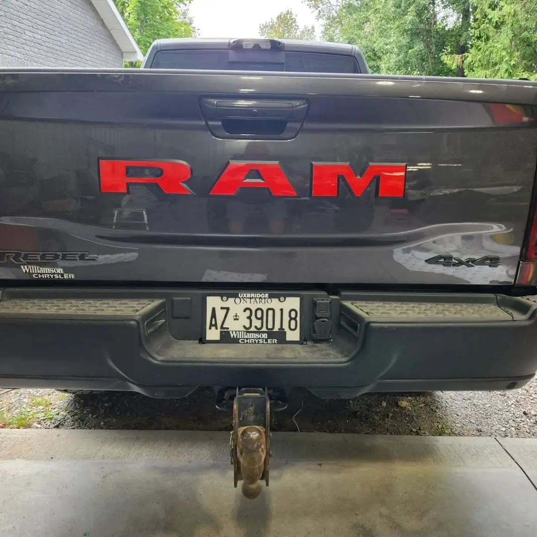 Ram truck with red tailgate and hood accents