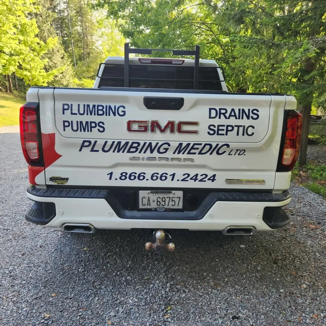 Plumbing Medic GMC pickup with red maple-leaf lettering