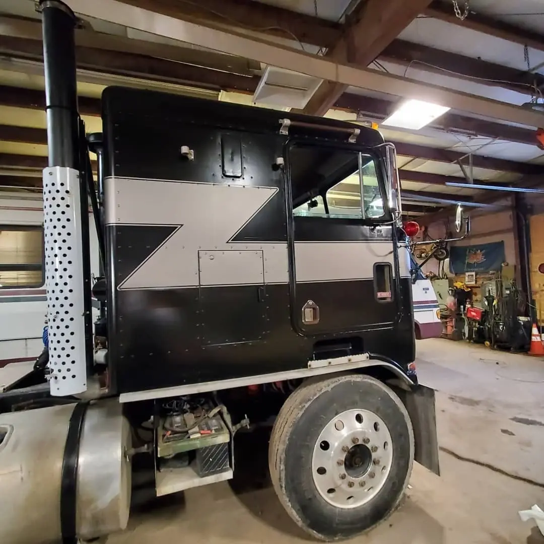 Kenworth cab-over truck with blue striping