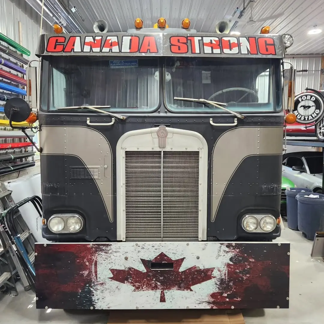 Old Kenworth cab-over with a Canadian flag wrap