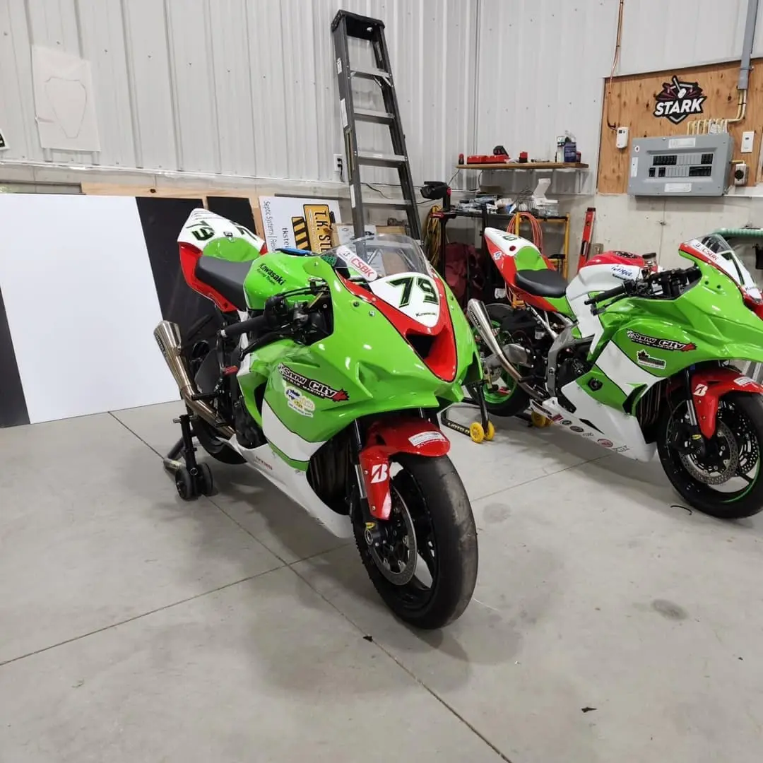 Green race motorcycles with custom wraps