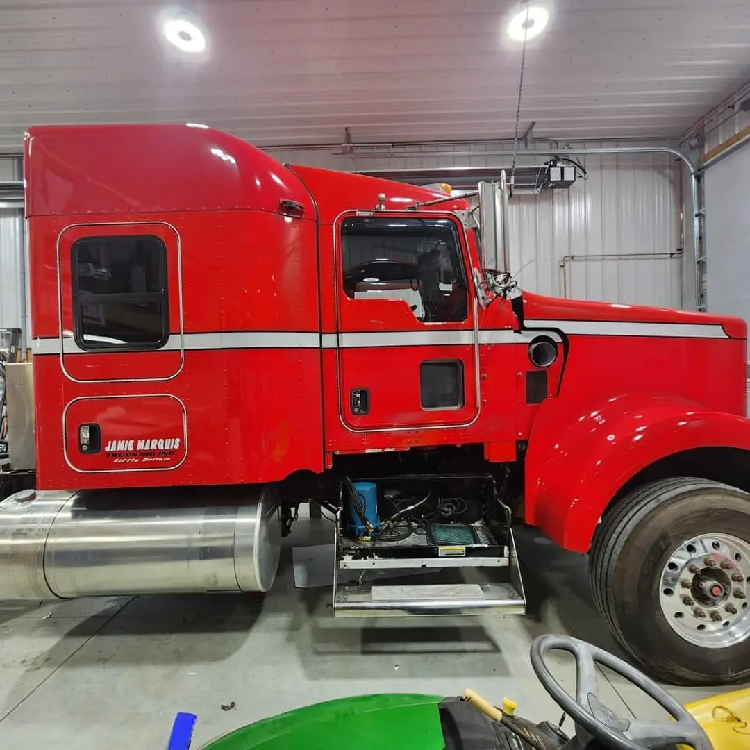 Red Jamie Marquis Trucking tractor and tanker with lettering and striping