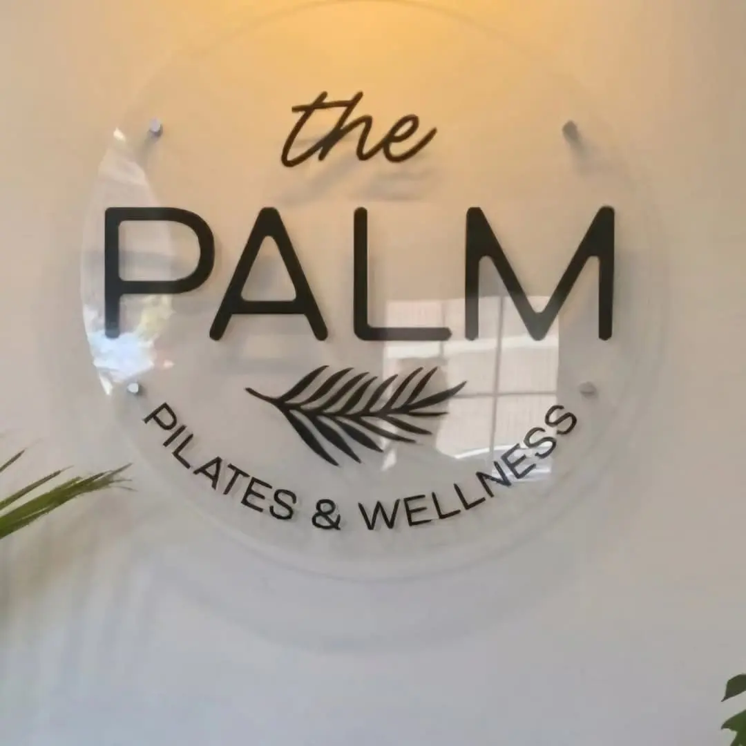 Acrylic pin-mounted sign for The Palm Pilates & Wellness