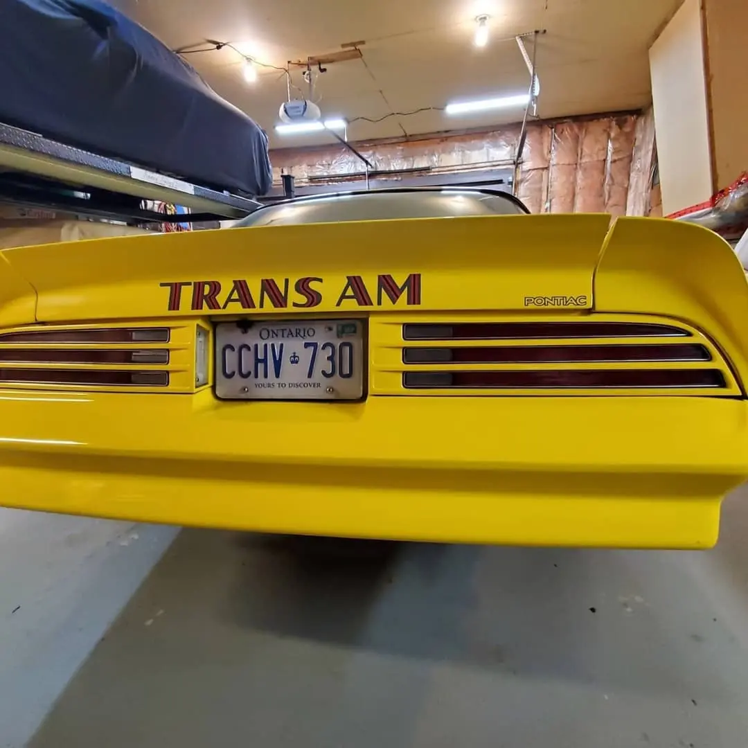 Yellow Pontiac Trans Am with the firebird hood decal