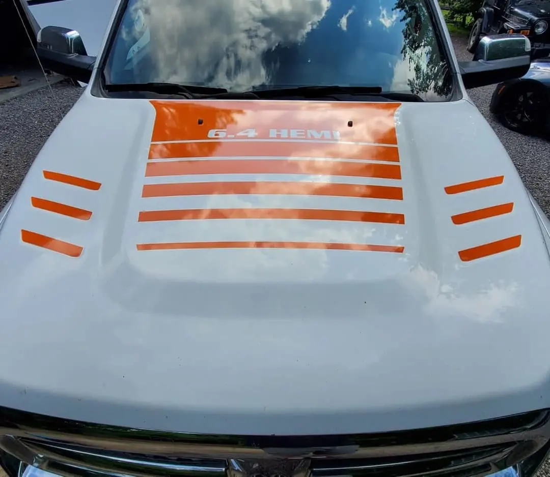 White Ram pickup with orange hood stripes