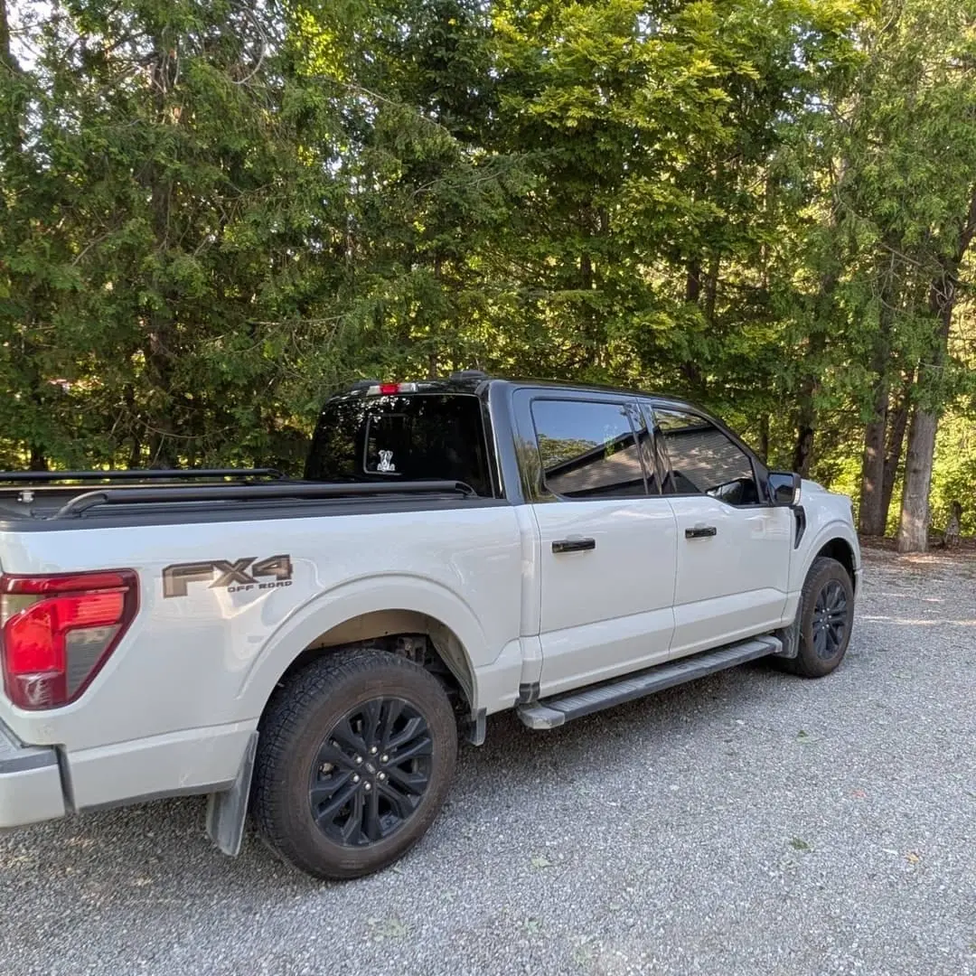 White Ford F-150 with a gloss black roof wrap