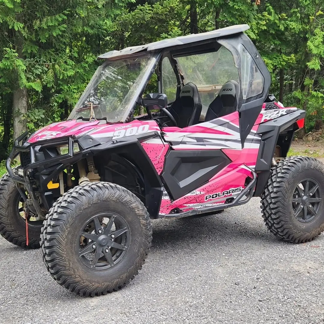 Polaris RZR side-by-side wrapped in pink and black
