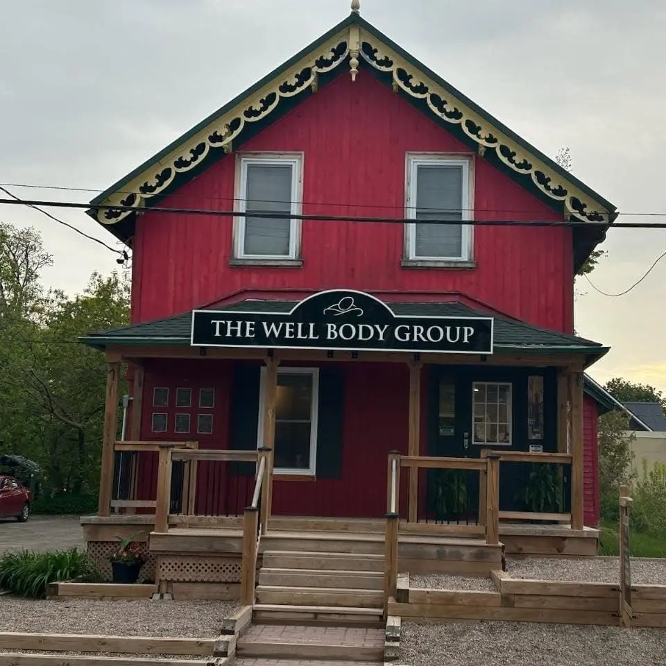 The Well Body Group signs on a stone building